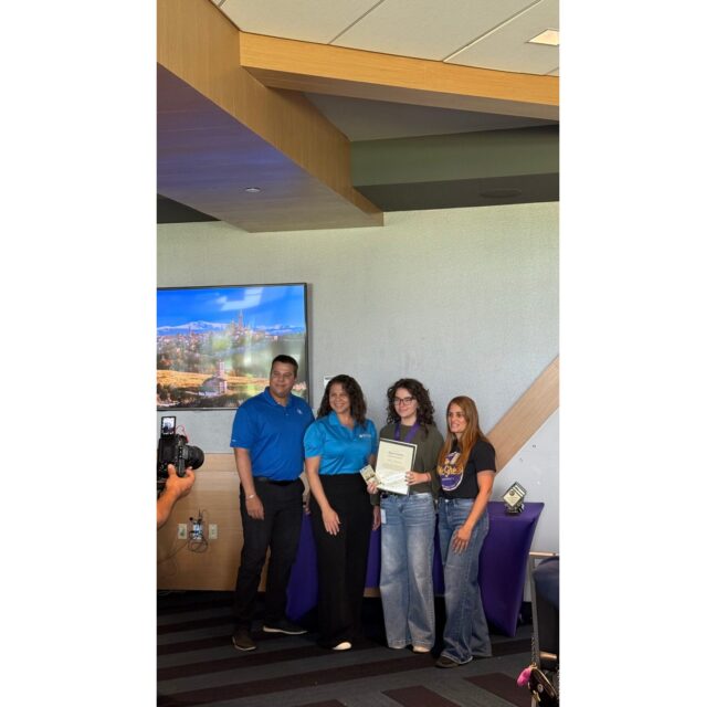 Kamp Kionne interns and program staff with a certificate at their summer wrap-up