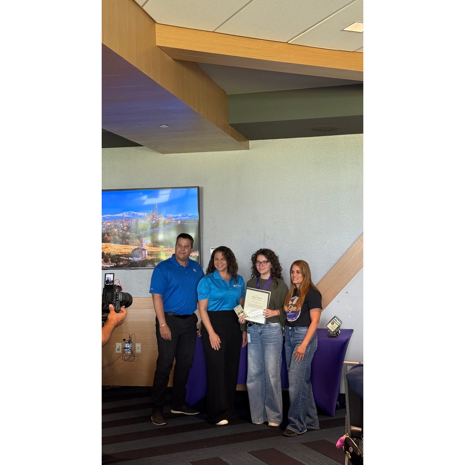 Kamp Kionne interns and program staff with a certificate at their summer wrap-up