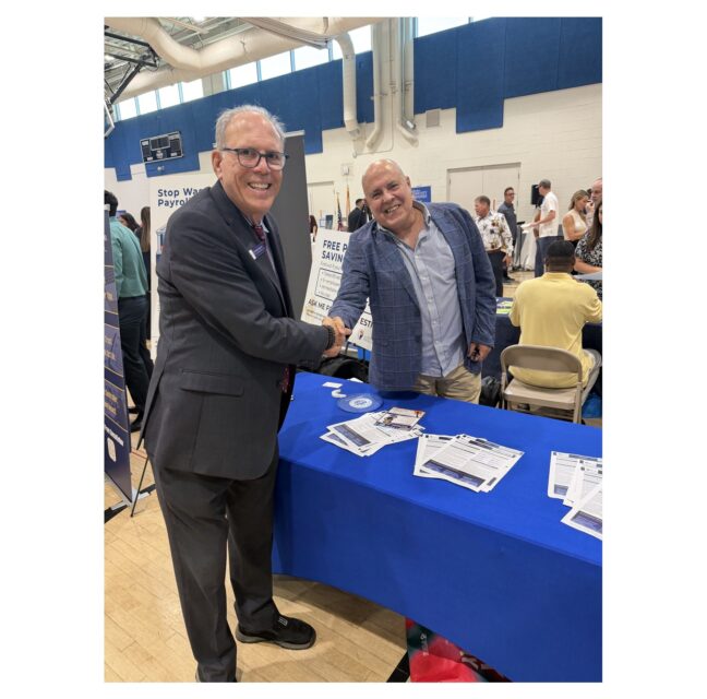 Business owners shaking hands at the Small Business Expo at the South Dade YMCA