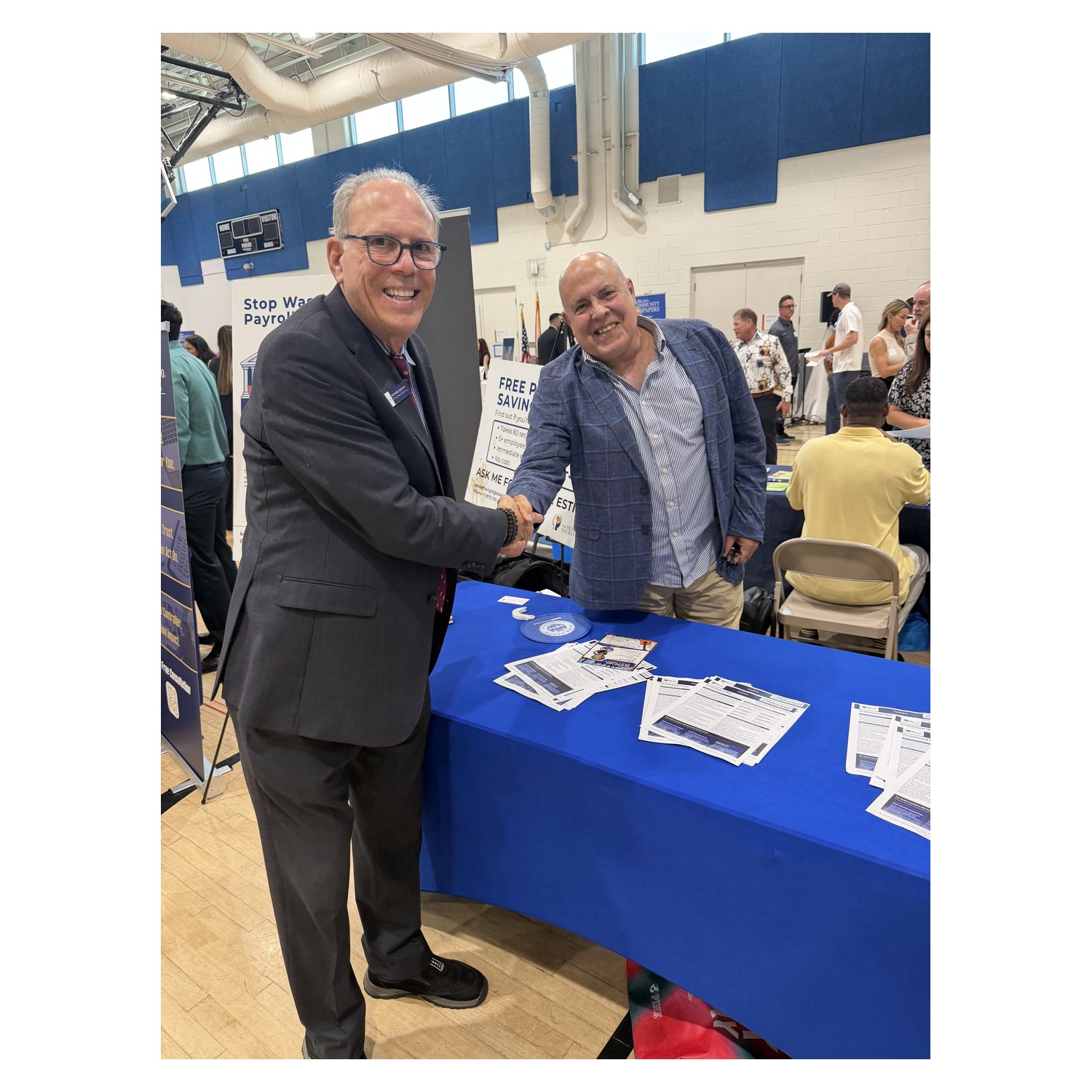 Business owners shaking hands at the Small Business Expo at the South Dade YMCA