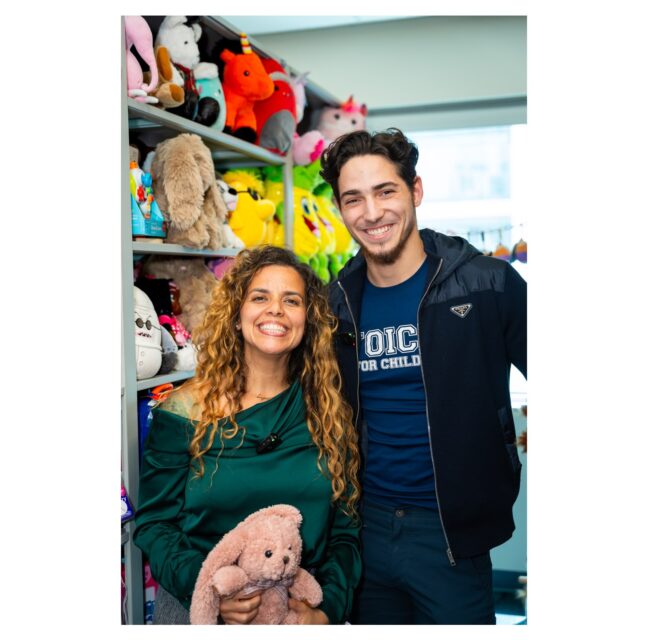 Voices For Children staff among toys and stuffed animals in the Comfort Closet