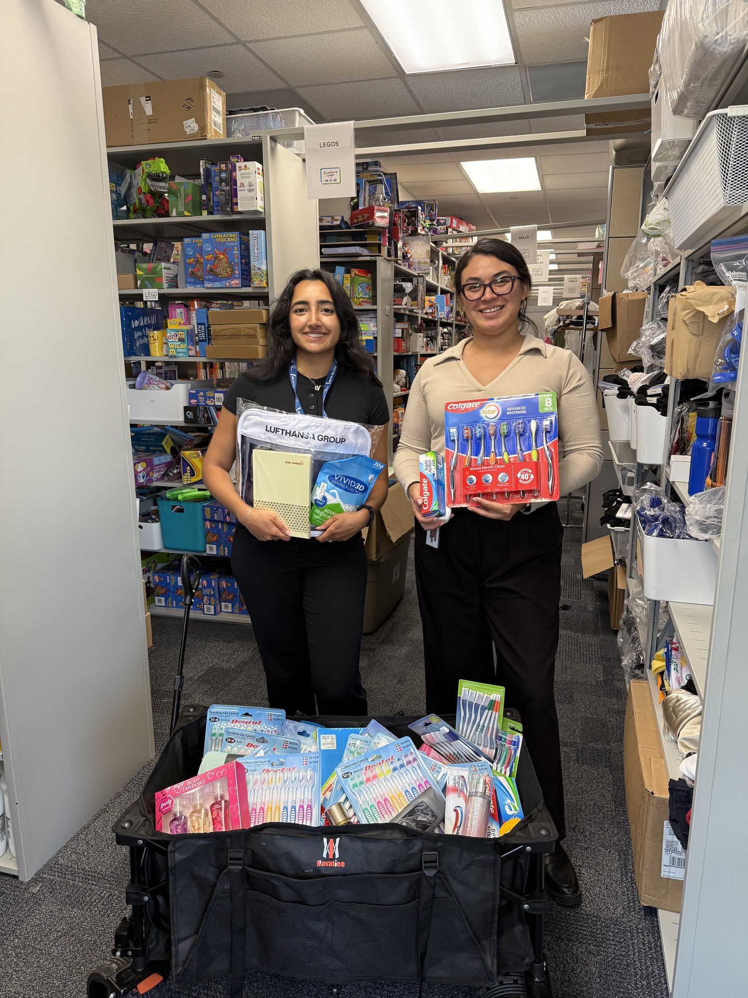 Volunteers with donated school supplies and toothbrushes for the Comfort Closet