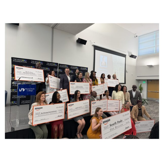 Nonprofit leaders holding Amazon grant checks at Miami Dade College Homestead