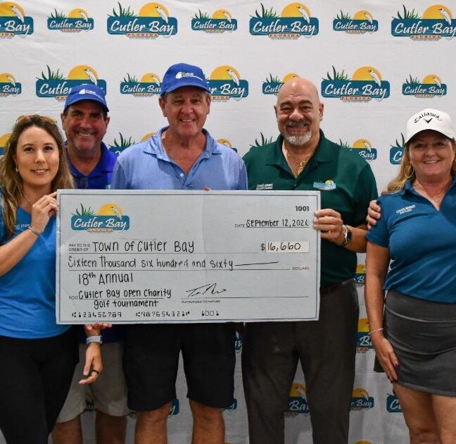 Cutler Bay Open Charity Golf Tournament team holding a big Town of Cutler Bay check
