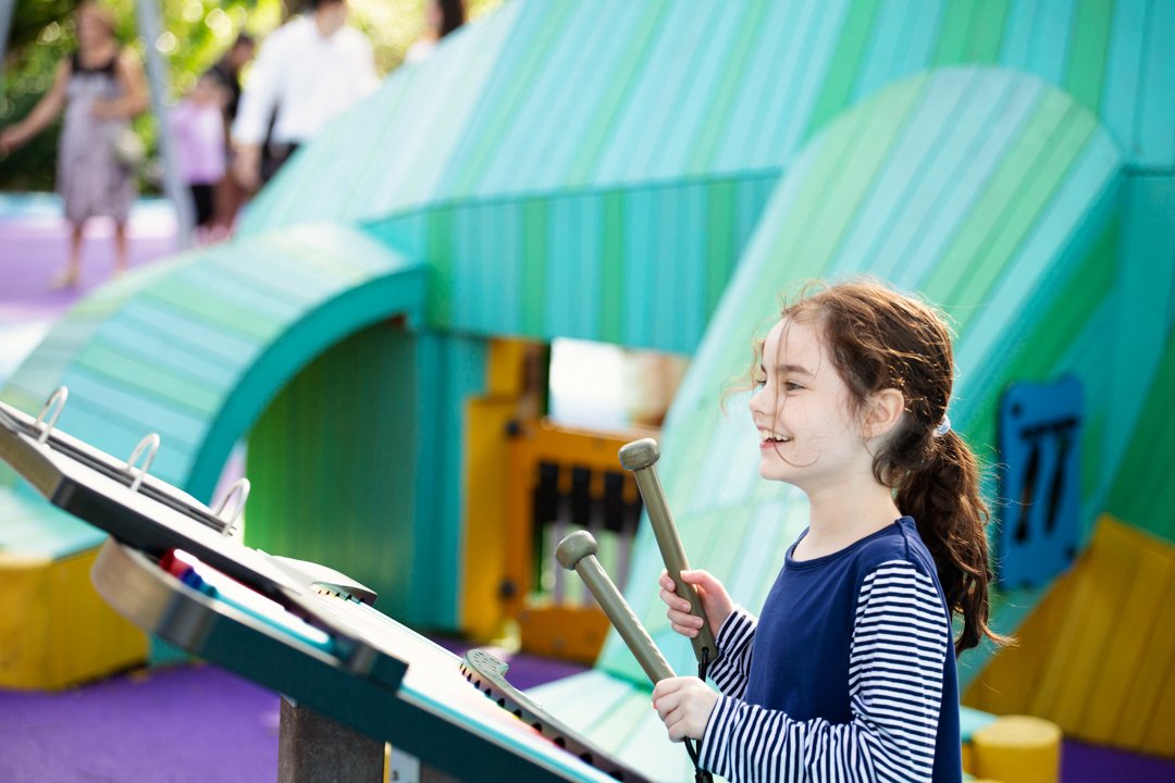 A child plays an outdoor instrument at the Pinecrest Gardens playground. Photo: Pinecrest Gardens